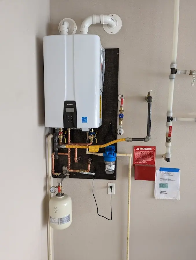 Professional plumber installing copper piping in a Warrenton home